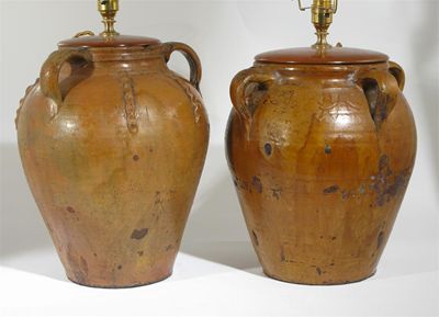 Appraisal: Two glazed earthenware lamps with loop handles one with simple