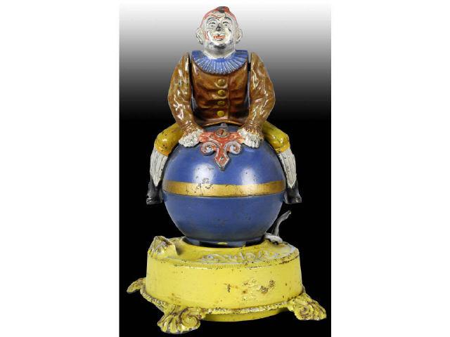 Appraisal: Cast Iron Clown On Globe Mechanical Bank Description Original box