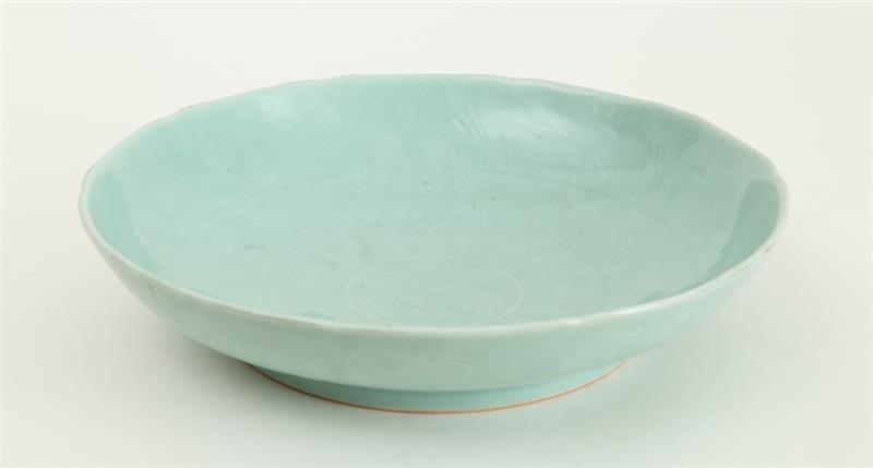 Appraisal: CHINESE ENGRAVED AND CELADON-GLAZED PORCELAIN FOOTED BASIN The interior with