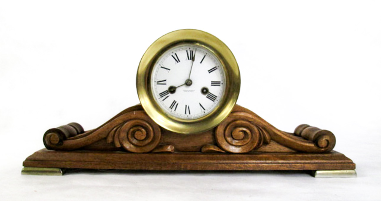 Appraisal: AN AMERICAN BRASS AND CARVED MAHOGANY SHIP'S CLOCK Waterbury Clock