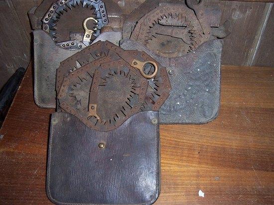 Appraisal: A chainsaw in a leather pouch and two similar examples