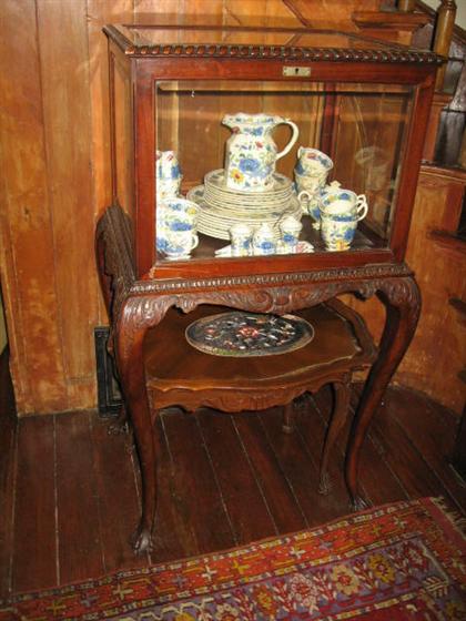 Appraisal: Carved mahogany display case on stand late th century Of