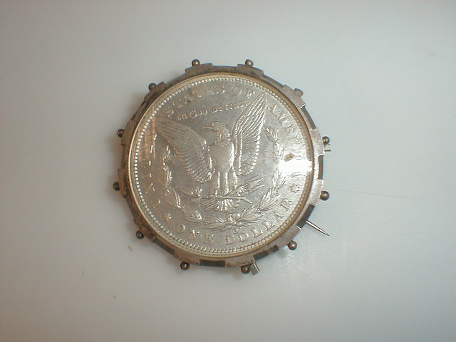 Appraisal: An American silver dollar mounted as a brooch