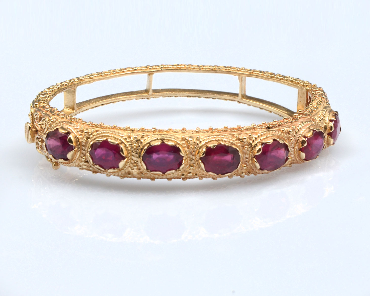 Appraisal: K RUBY BANGLE oval cabochon cut rubies are featured in