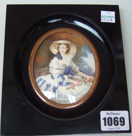 Appraisal: An oval portrait miniature of a lady wearing a hat