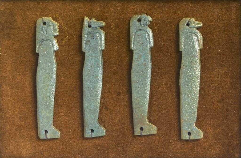 Appraisal: ANCIENT EGYPT A SET OF FOUR TURQUOISE FAIENCE AMULETS XXII-XXIII