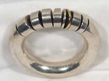 Appraisal: A Georg Jensen silver bangle bracelet with a gold segment