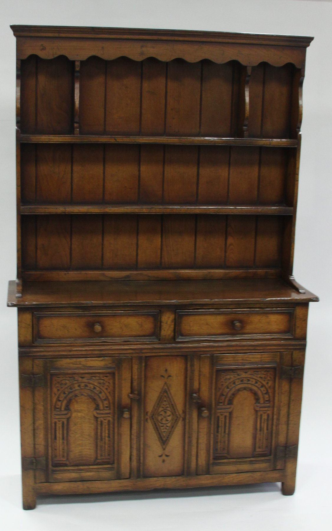 Appraisal: An oak dresser with shelves over fitted cupboards and drawers