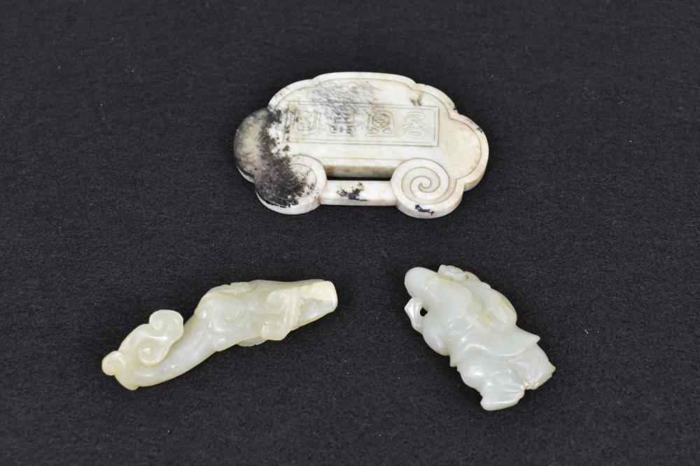 Appraisal: THREE CHINESE JADE STUDIESComprising a white jade clasp-form study with