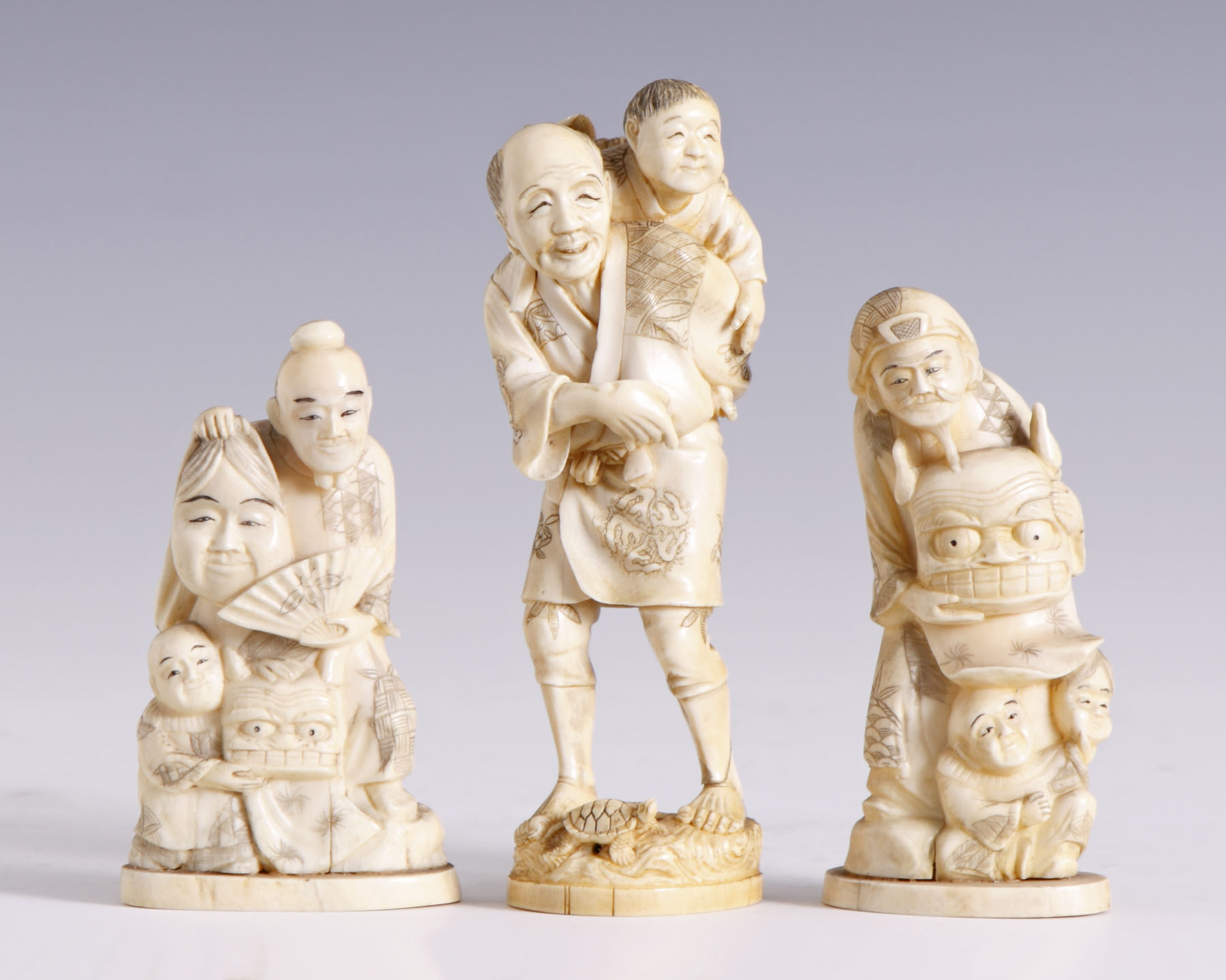 Appraisal: Sgn Carved Japanese Figure Holding masks Excellent Ht