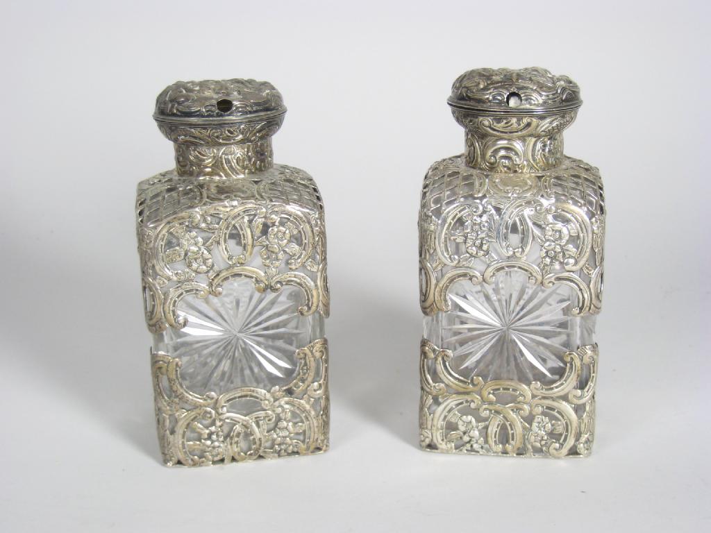 Appraisal: Pair of Victorian silver covered square cut-glass Scent Bottles embossed