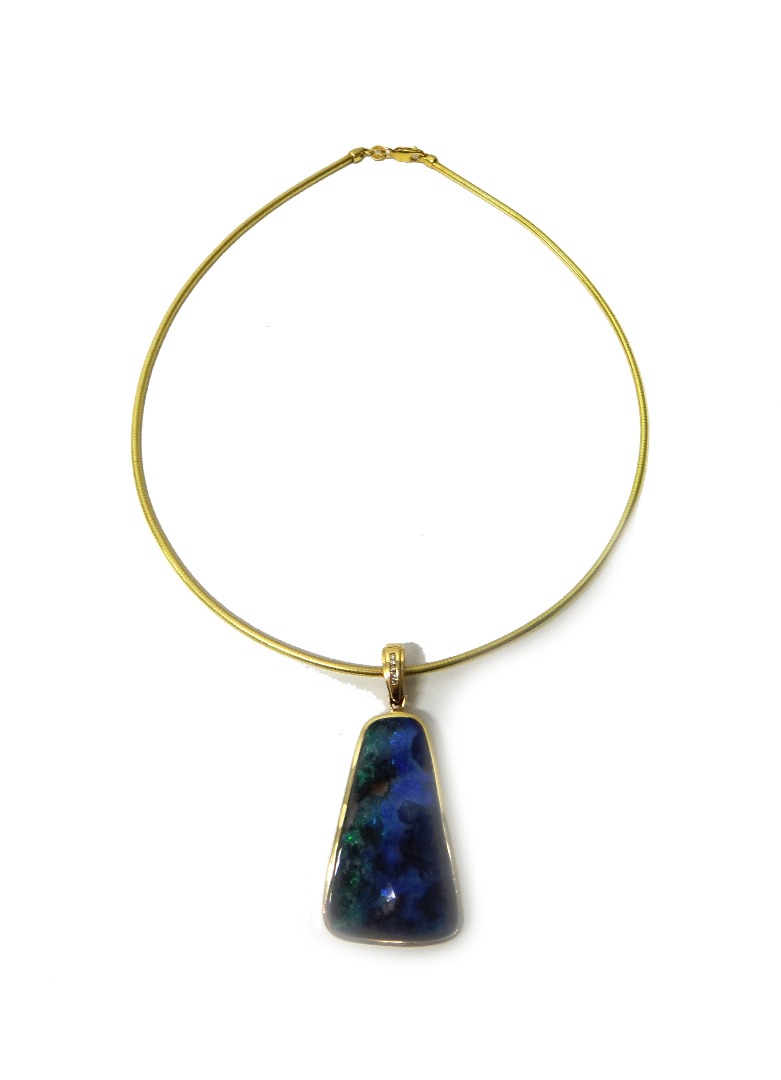 Appraisal: A gold mounted opal matrix pendant having a diamond set