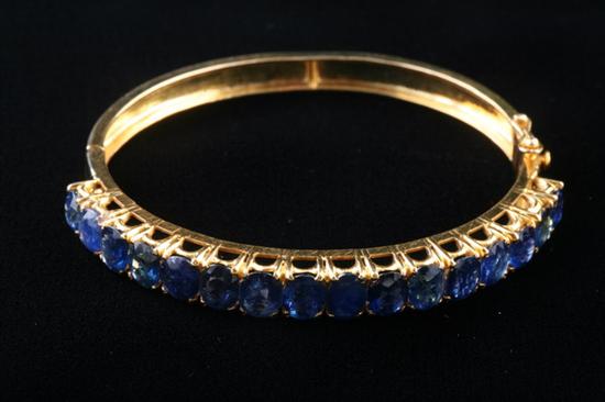 Appraisal: K YELLOW GOLD AND SAPPHIRE HINGED OVAL BANGLE BRACELET Top