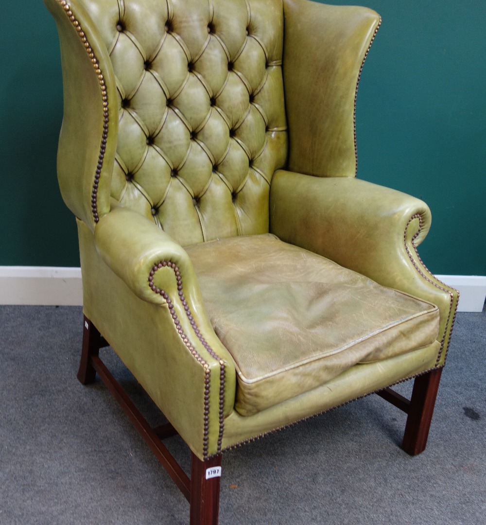 Appraisal: A George II style brass studded green leather upholstered wing