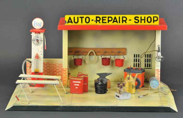 Appraisal: DOLL AUTO REPAIR SHOP Germany lithographed tin depicts a full