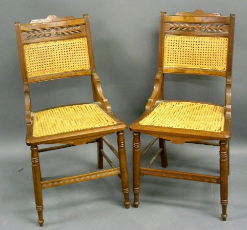 Appraisal: Pair of Eastlake walnut side chairs with caned seats h