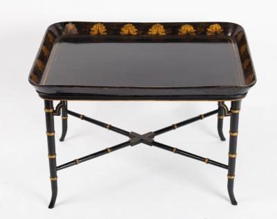 Appraisal: A black lacquered tray mounted on a later ebonised faux