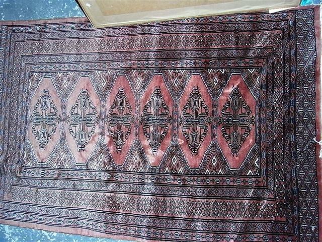 Appraisal: A BOKHARA TYPE WOOL RUG with central medallion and multiple