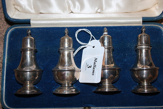 Appraisal: A SET OF FOUR CASED SILVER PEPPERETTES in a Georgian