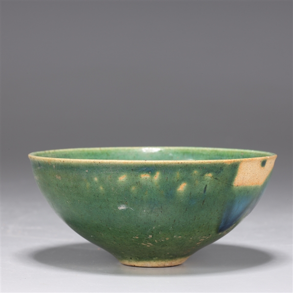 Appraisal: Chinese green glazed ceramic tea bowl with floral designs to