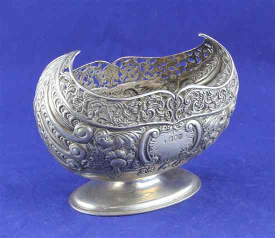 Appraisal: An Edwardian repousse silver boat shaped vase with pierced border