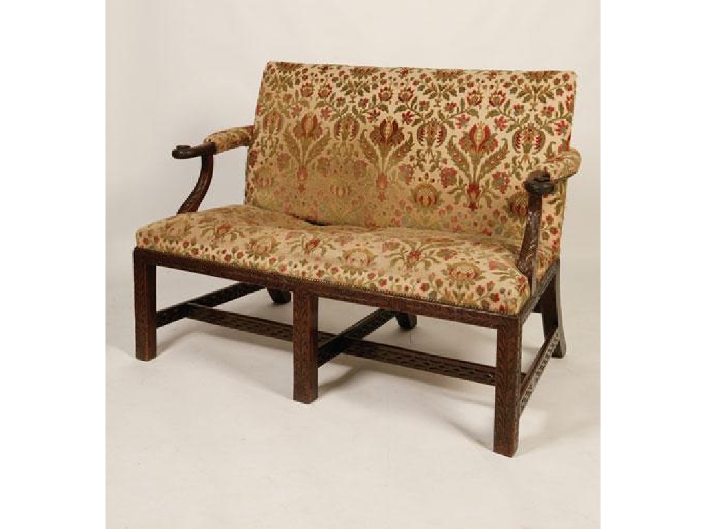 Appraisal: A GEORGE III IRISH MAHOGANY SETTEE with acanthus-carved outscroll arms