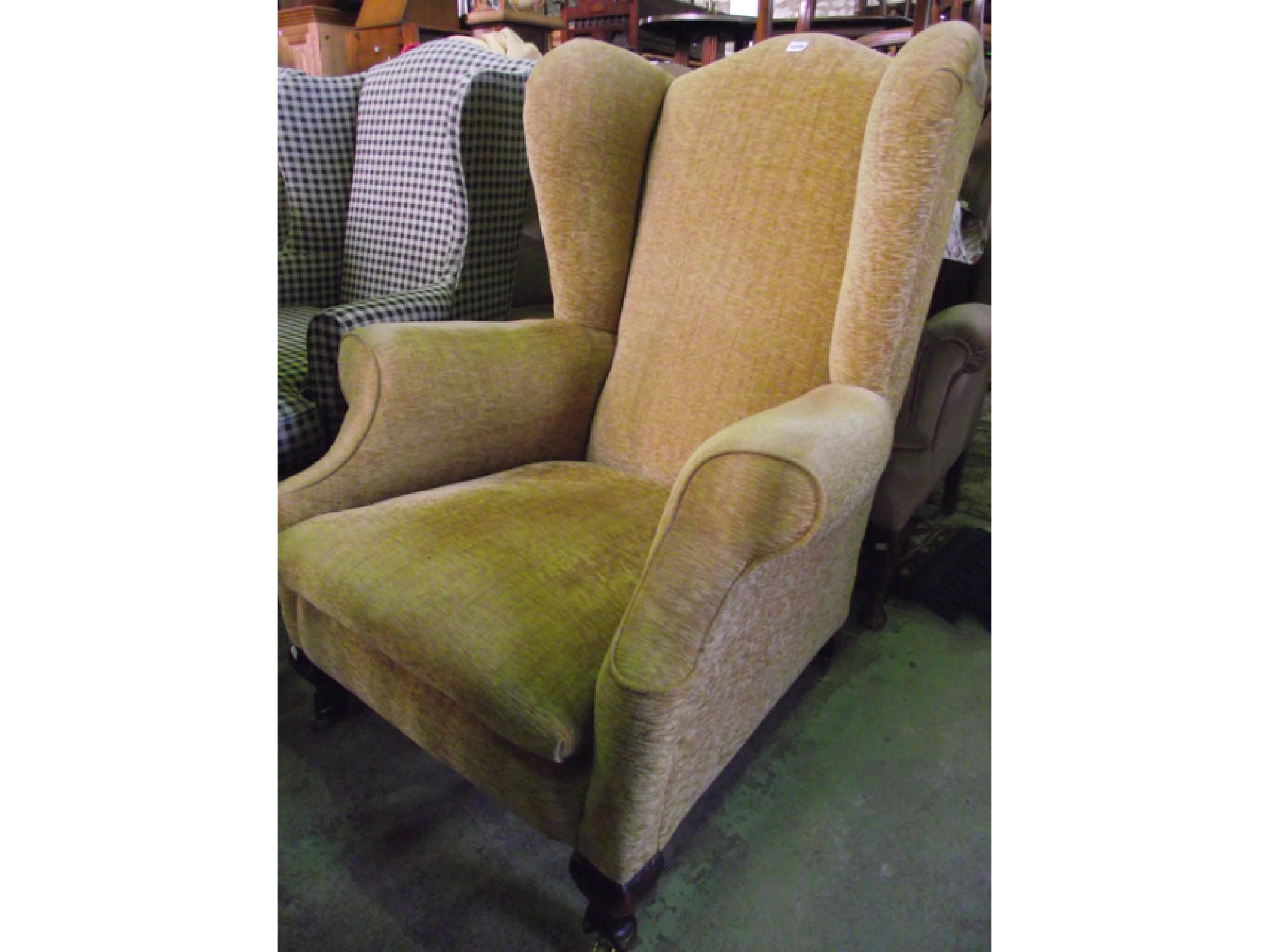 Appraisal: A substantial wing armchair in the Georgian style with recently