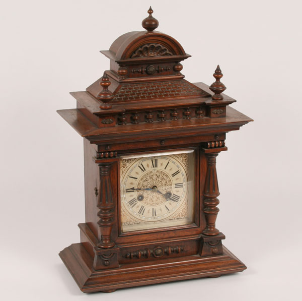 Appraisal: Extensively carved mantle clock with Northern European influences walnut case