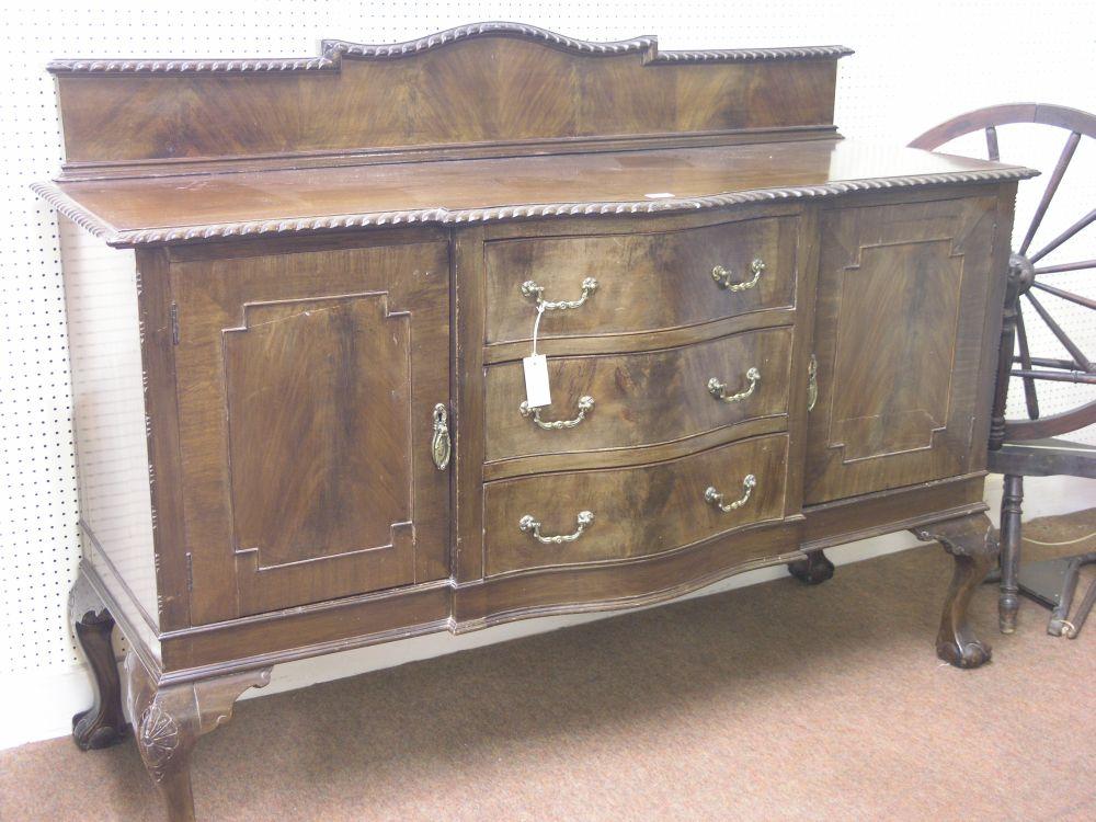 Appraisal: An early th century serpentine fronted mahogany sideboard with raised