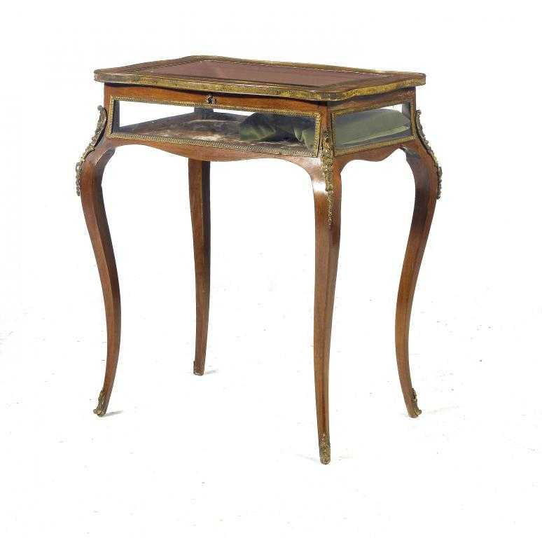 Appraisal: A FRENCH MAHOGANY DISPLAY TABLE of serpentine form with ormolu