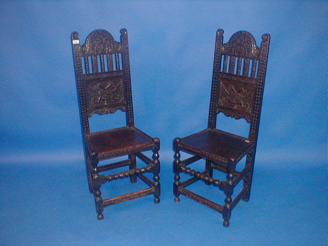 Appraisal: A pair of high back carved oak hall chairs