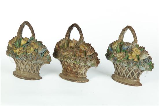 Appraisal: THREE MATCHING CAST-IRON BASKET OF FLOWERS DOOR STOPS American st