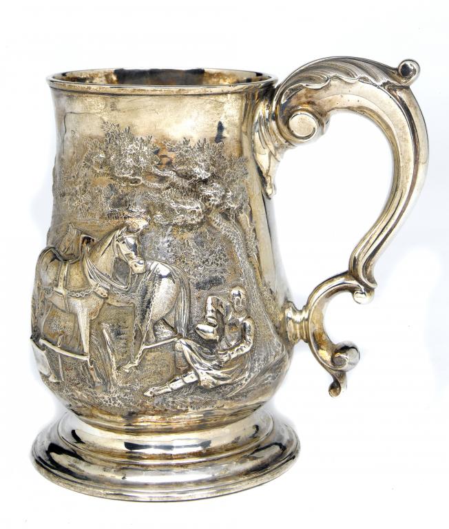 Appraisal: A GEORGE III MUG with leaf capped scrolling handle on