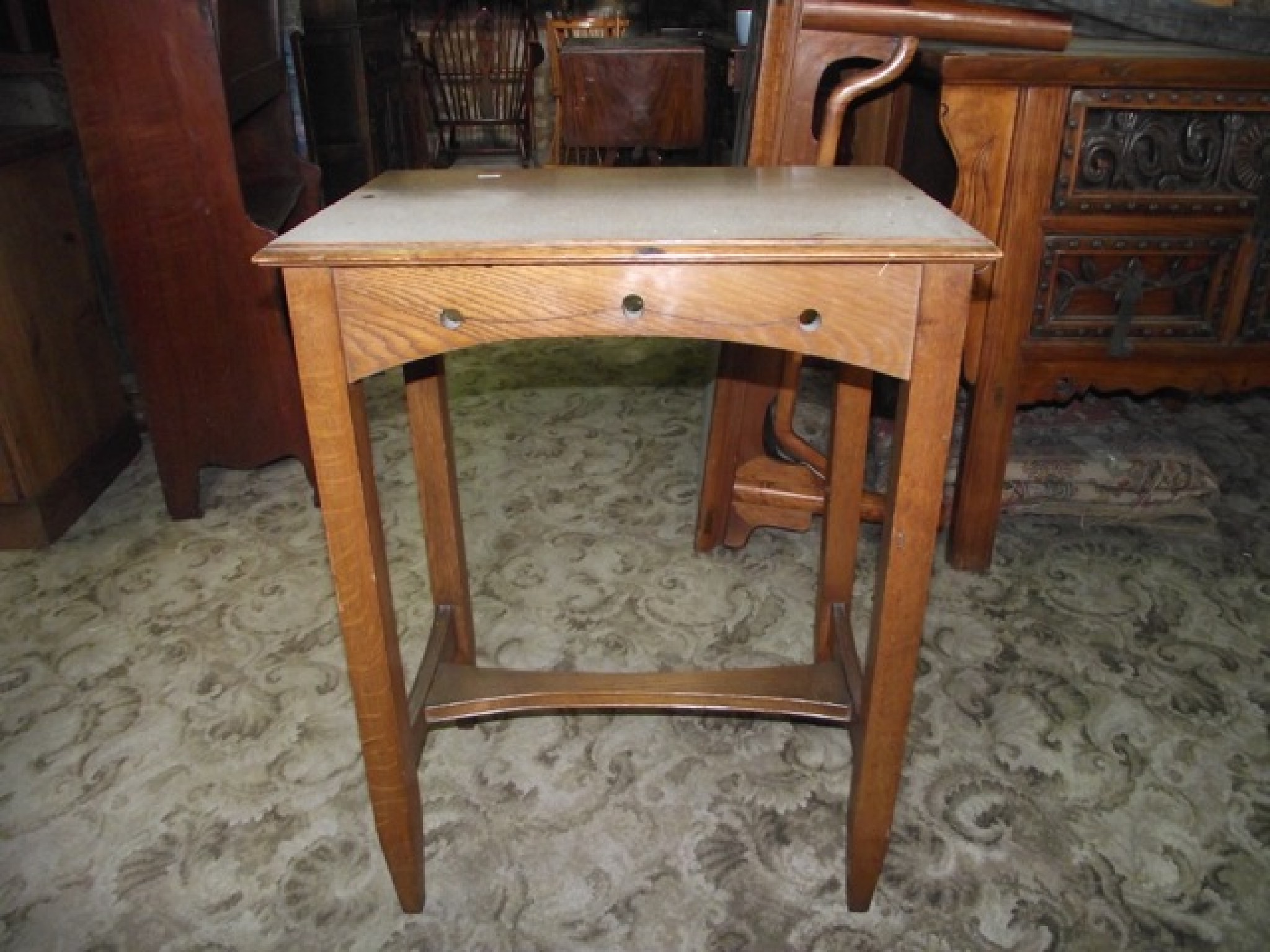 Appraisal: An arts and crafts style oak occasional table of rectangular