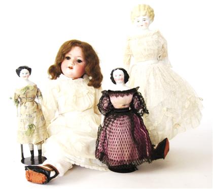 Appraisal: Four porcelain headed dolls and belljar and standarmand marseille and