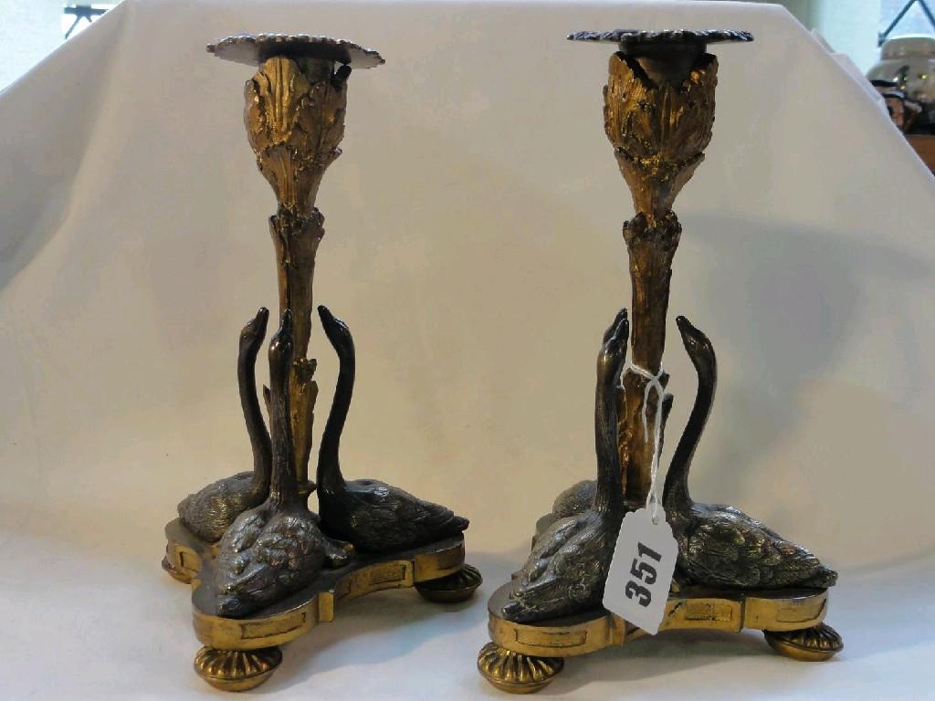 Appraisal: A pair of th century cast brass and bronze candlesticks