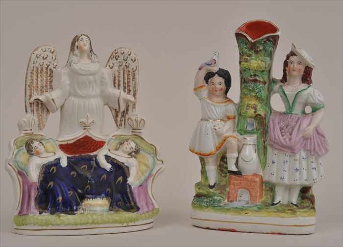 Appraisal: STAFFORDSHIRE FIGURAL SPILL VASE AND A FIGURE GROUP Modeled as