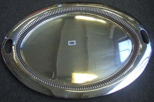 Appraisal: A plated oval twin handled tray decorated with a lobed