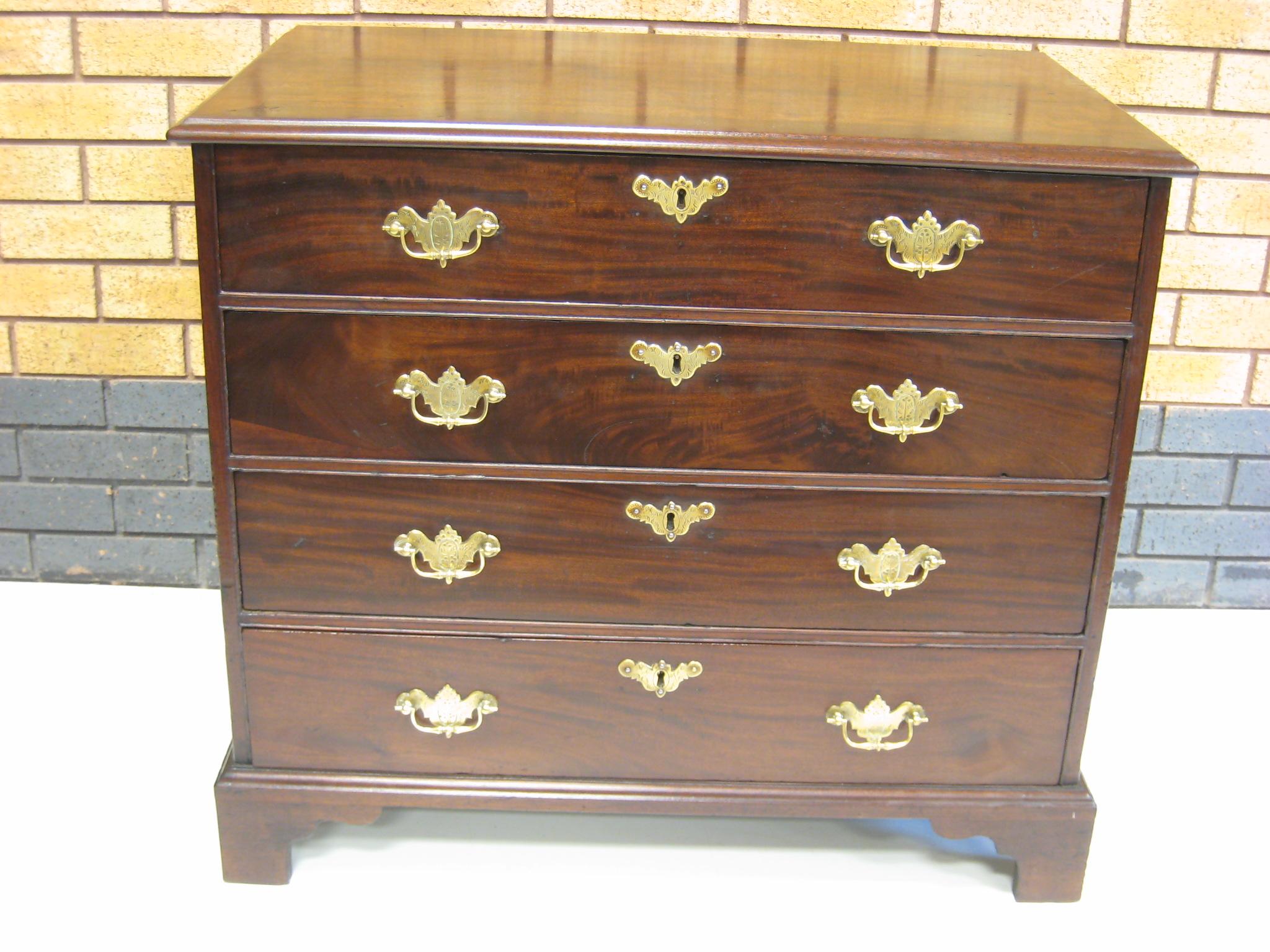 Appraisal: A Georgian mahogany Chest of four long graduated drawers the