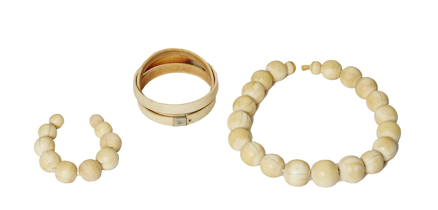 Appraisal: THREE INDIAN IVORY BANGLE BRACELETS AND IVORY BEADS ON STRANDS