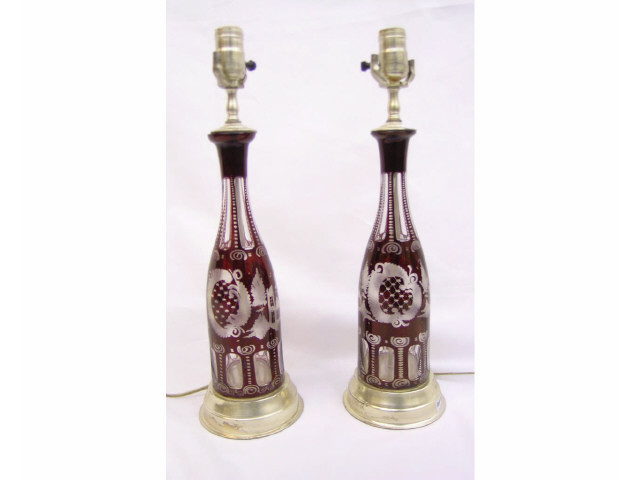 Appraisal: Pair of Bohemian ruby cut-to-clear glass table lamps with matching