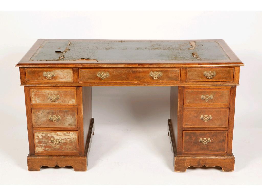 Appraisal: A WALNUT VENEERED AND CROSSBANDED TWIN PEDESTAL KNEEHOLE WRITING DESK