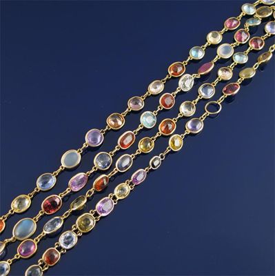 Appraisal: A gold long guard chain mounted with assorted coloured gemstones