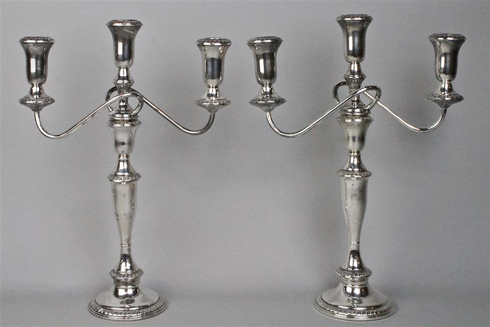 Appraisal: PAIR OF WEIGHTED STERLING CANDELABRA each with scrolling candleholders decorated