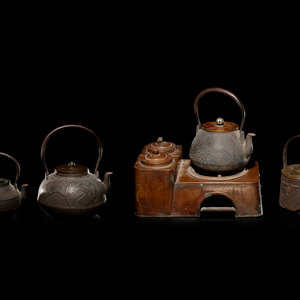 Appraisal: Four Japanese Cast Iron Teapots Tetsubin and Copper Burner Stand