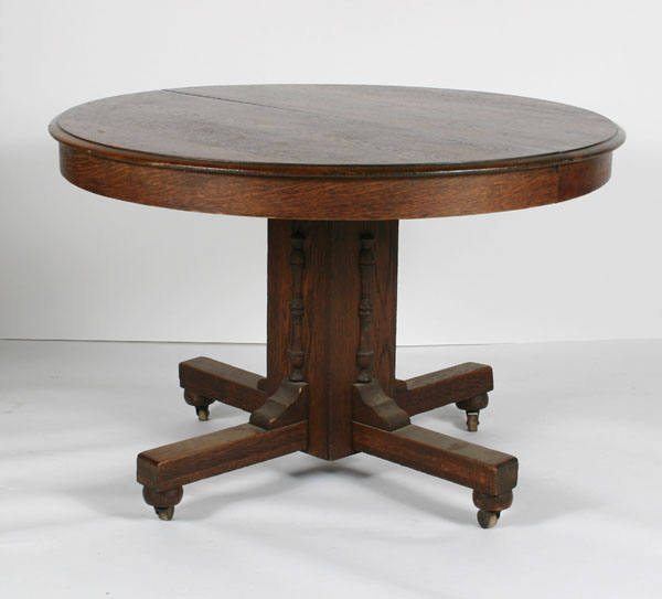 Appraisal: Round oak table with center pedestal four braced legs architectural