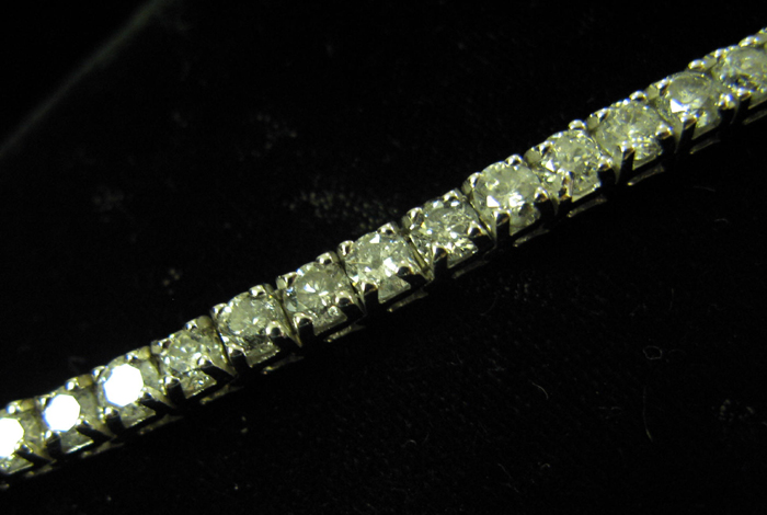 Appraisal: DIAMOND AND FOURTEEN KARAT WHITE GOLD LINE BRACELET WITH APPRAISAL