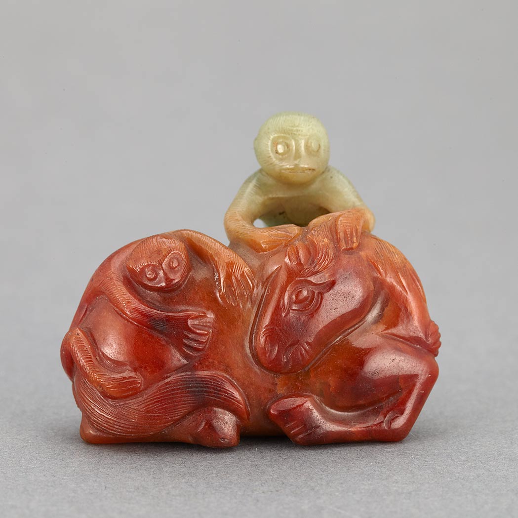 Appraisal: Chinese Red and Celadon Jade Monkey Group Early th century