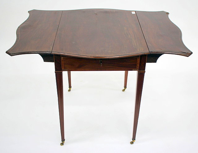 Appraisal: A GEORGE III MAHOGANY SERPENTINE TOPPED PEMBROKE TABLE with walnut