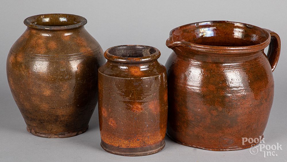 Appraisal: Redware pitcher together with two crocks th c Redware pitcher